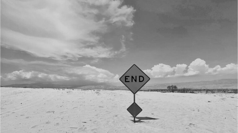 End of the road sign representing M&A exit decisions and risk timing