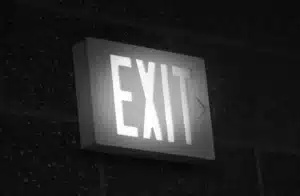 Illuminated exit sign representing digital media M&A valuation drivers and the decision to exit or sell a business