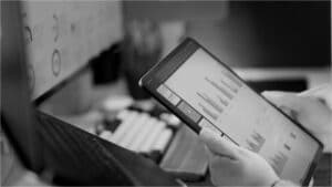 Analyst reviewing business valuation dashboards and EBITDA performance metrics during an M&A transaction assessment